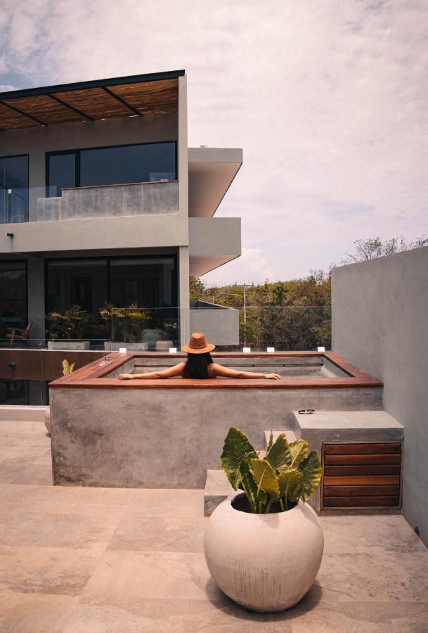 Xperience Tulum Hotel Exterior photo A woman relaxing in a rooftop plunge pool